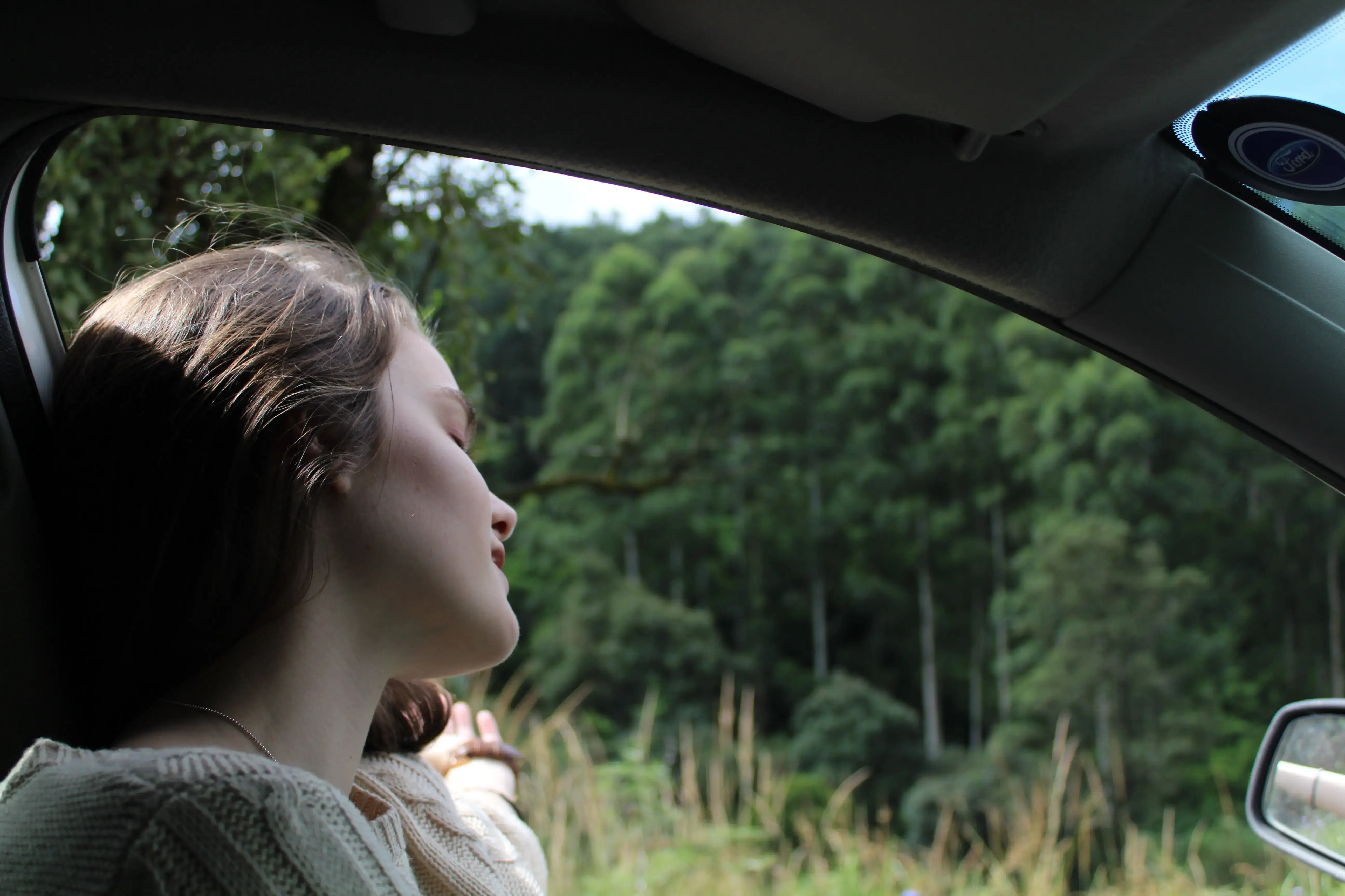 Woman in car enjoying the day